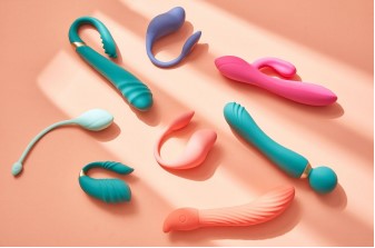 Eight rubber items are laying down on an orange background and they are all different shapes and colours. There are three dark green and one pale green while the others are orange, pink and purple. The all resemble a wand of differing styles and designs.