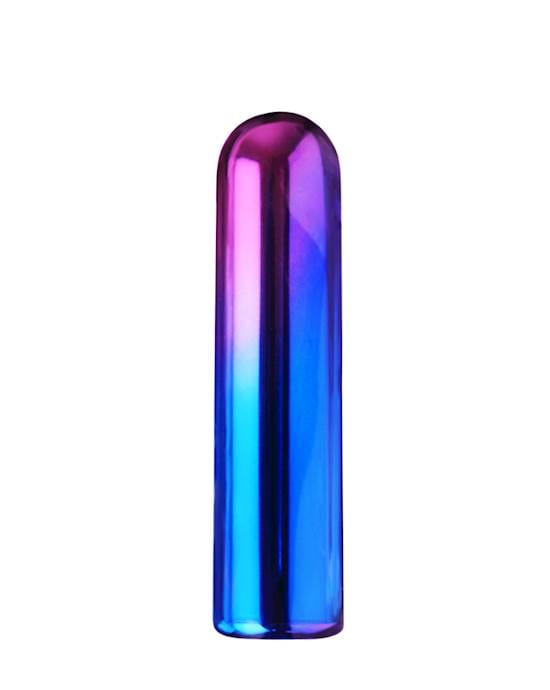 A tall,slim, dome shaped object in a shiny rainbow colour that includes pink, green, blue and purple. The tip of the dome is gently curved and it has a flat base. It is standing upright on a white background.