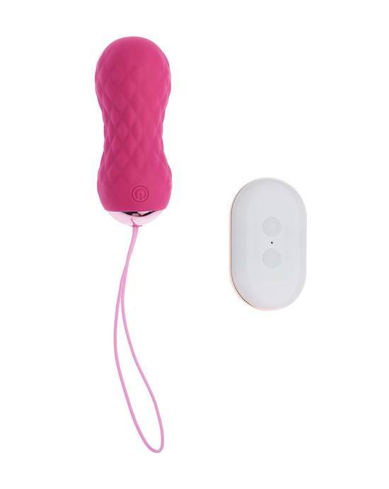 A pink rubber egg shaped object that has a pink looped string that looks like a tail and is pictured beside a white oval shaped item with two circle buttons in the middle.