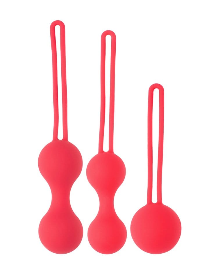 Three red silicone looking balls lay on a white background. Each ball is taller than the next and they have a long tail attached.
