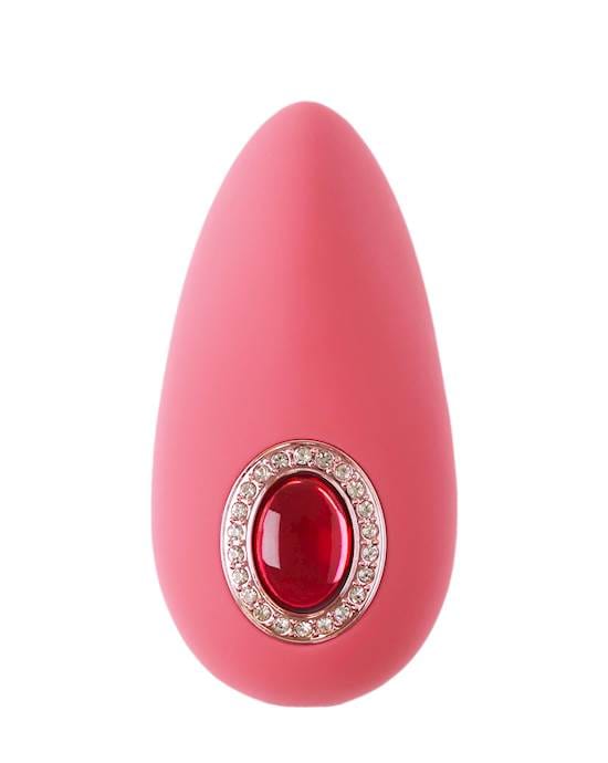 A pink object on a white background and the object is oval shaped with a curved point at one end and a big red jewell is in the centre.