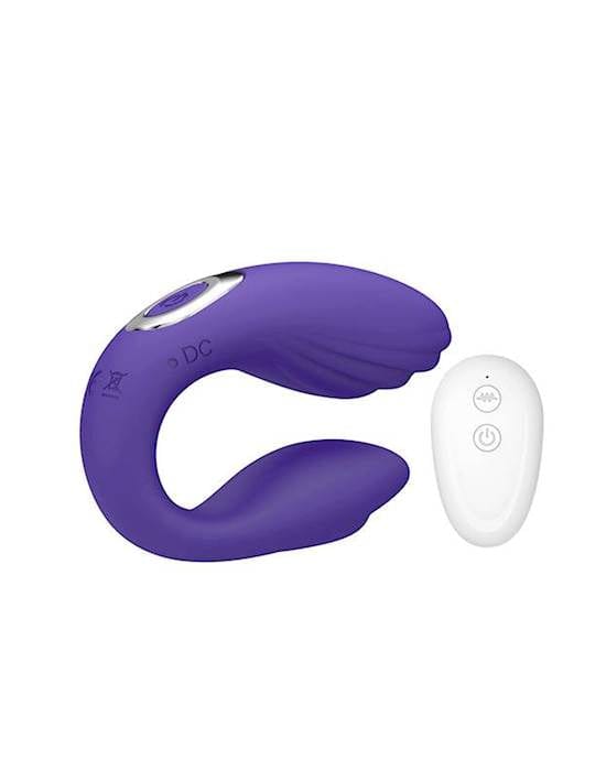 A purple coloured rubbery looking object which is sitting upright in a c-curve and has a silver shiny ring on top. Beside it sits a smaller white egg shaped object that has two buttons on it's face.