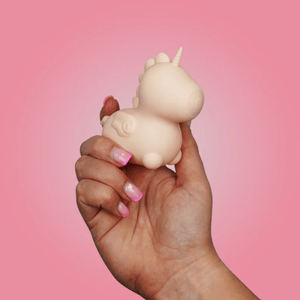 Open image in slideshow, Hand holding a small unicorn figurine against a pink background
