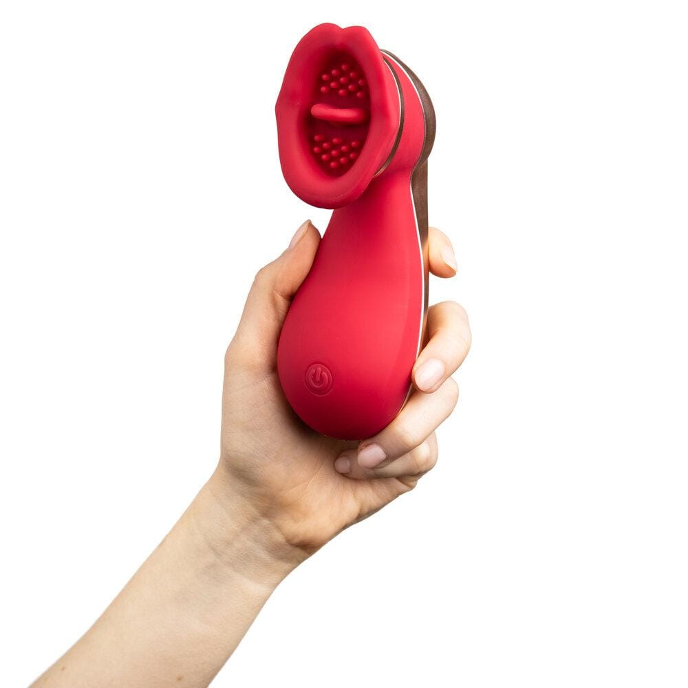 A well manicured hand holding the toy front on with the power button, whole front, and tongue visible.