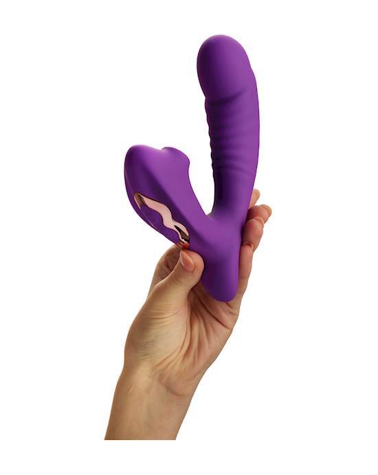 A woman's hand holding a purple V shaped product. The taller end has ribbing and the shorter end has a shiny gold backing.