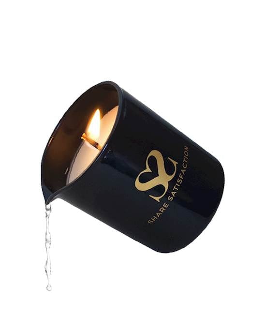 A black cup on a white background that  has a spout and is pouring a clear liquid from a burning candle. 